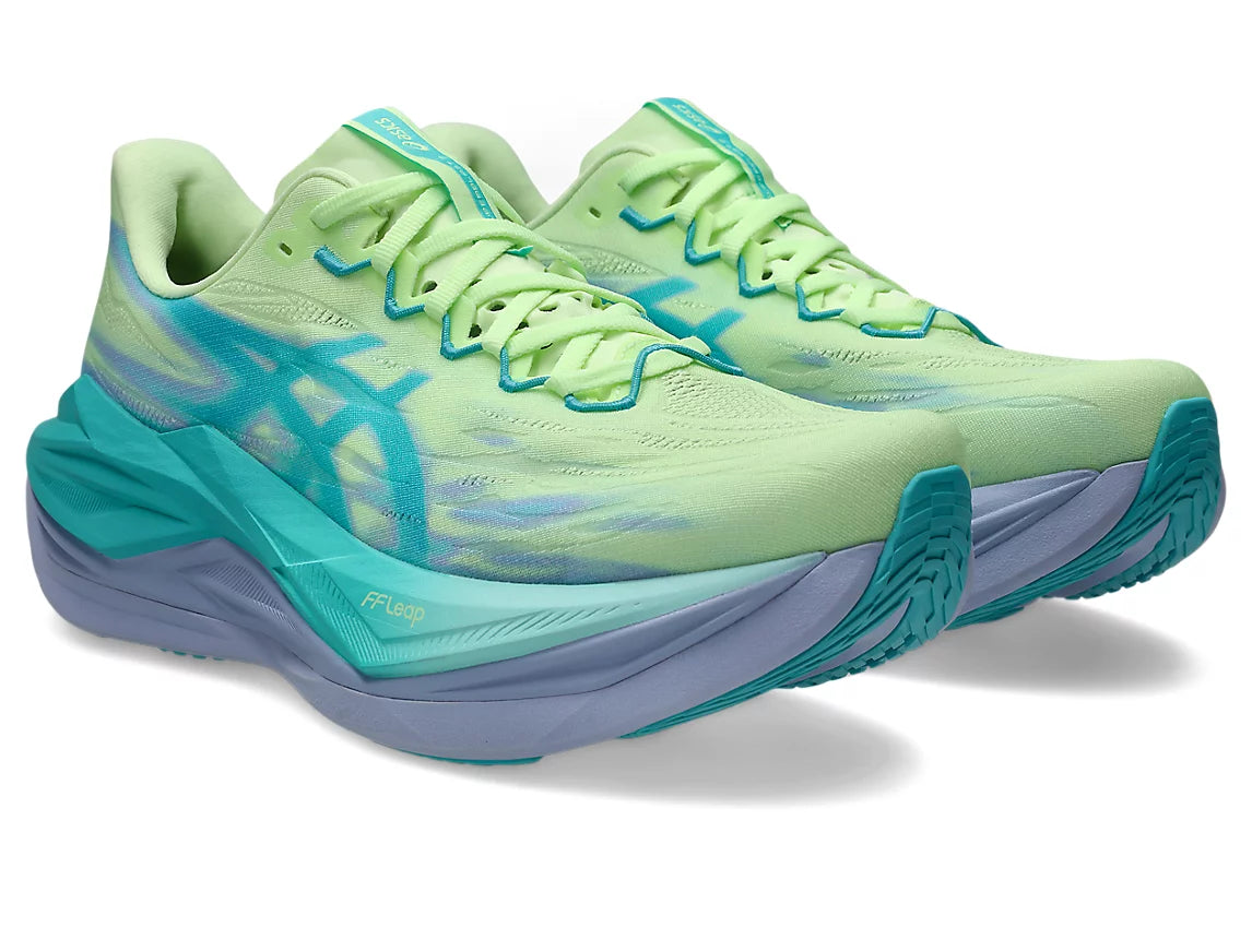 Pair of green and blue running shoes on a white background