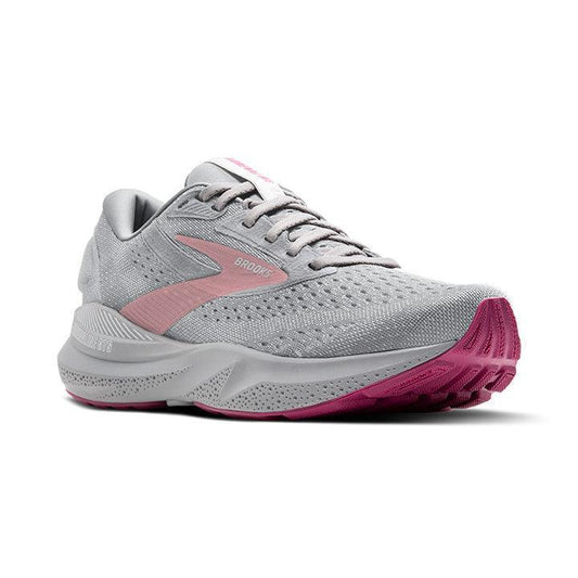 Diagonal angle of running shoes in gray with pink details on white background