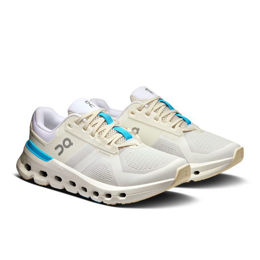 Angled Lateral side view of a pair of Women's white On Cloudrunner 2 running shoe with aquamarine blue detailing