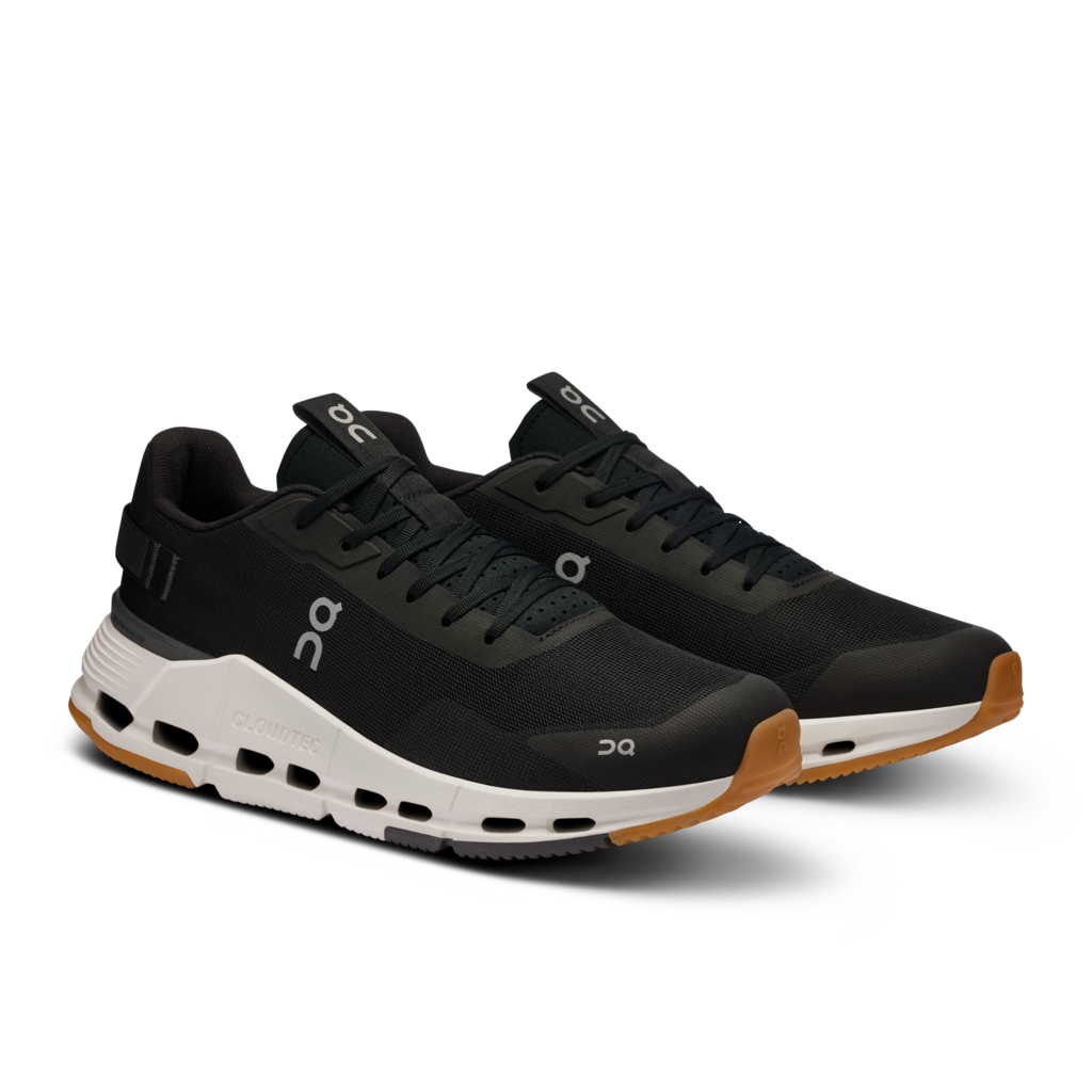 Black running shoes with white soles on a white background