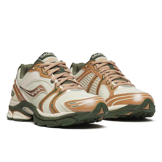 Diagonal view of pair of white lifestyle shoes with green and orange details on white background