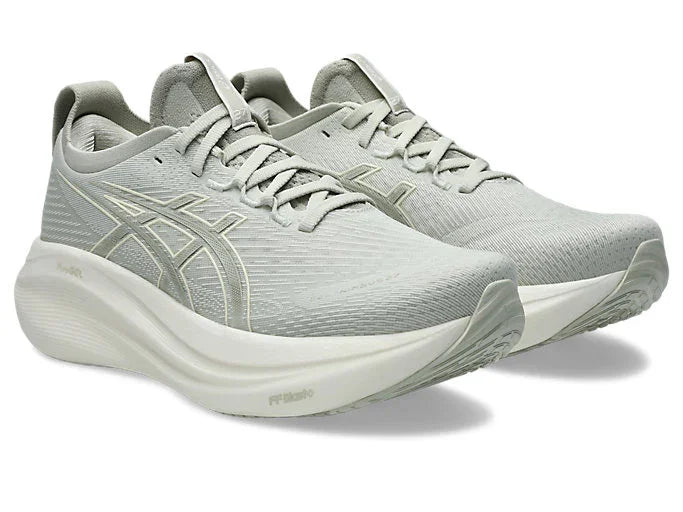 Angled side view of Women's gray Asics Nimbus 27 with white midsoles