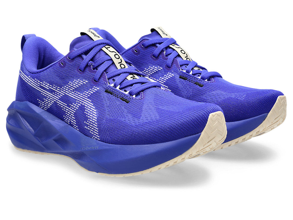 Blue running shoes with white soles on a white background