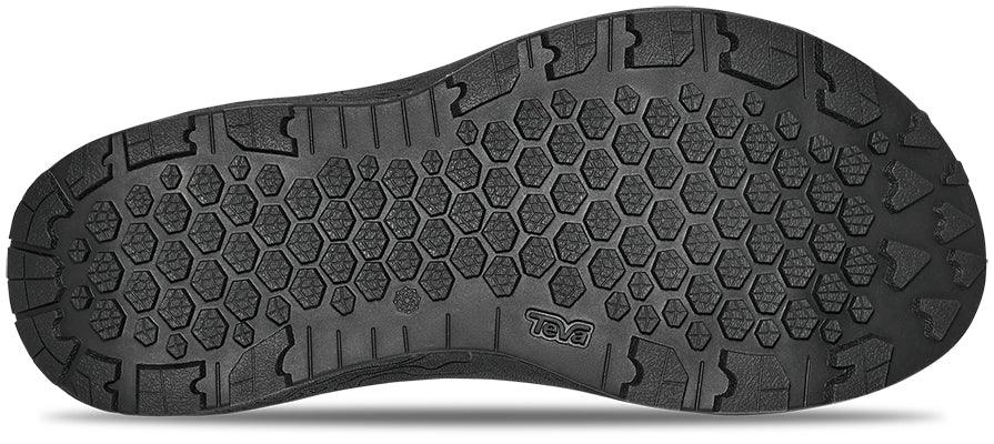 Underside view of black sandal to show the tread on white background