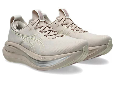 Beige Asics running shoes with light yellow and silver detailing on a white background