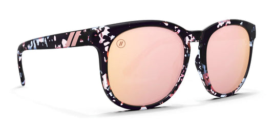 Sunglasses with floral patterned frame and pink lenses on a white background