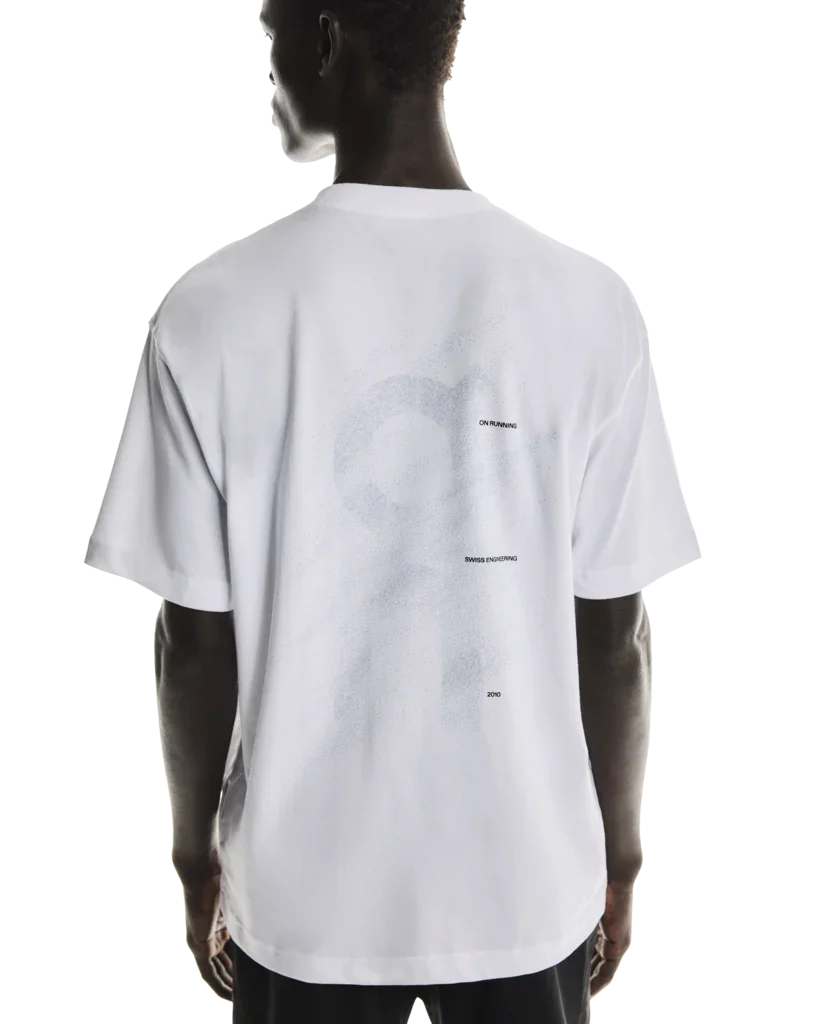 Rear view of model wearing white t-shirt with design on back