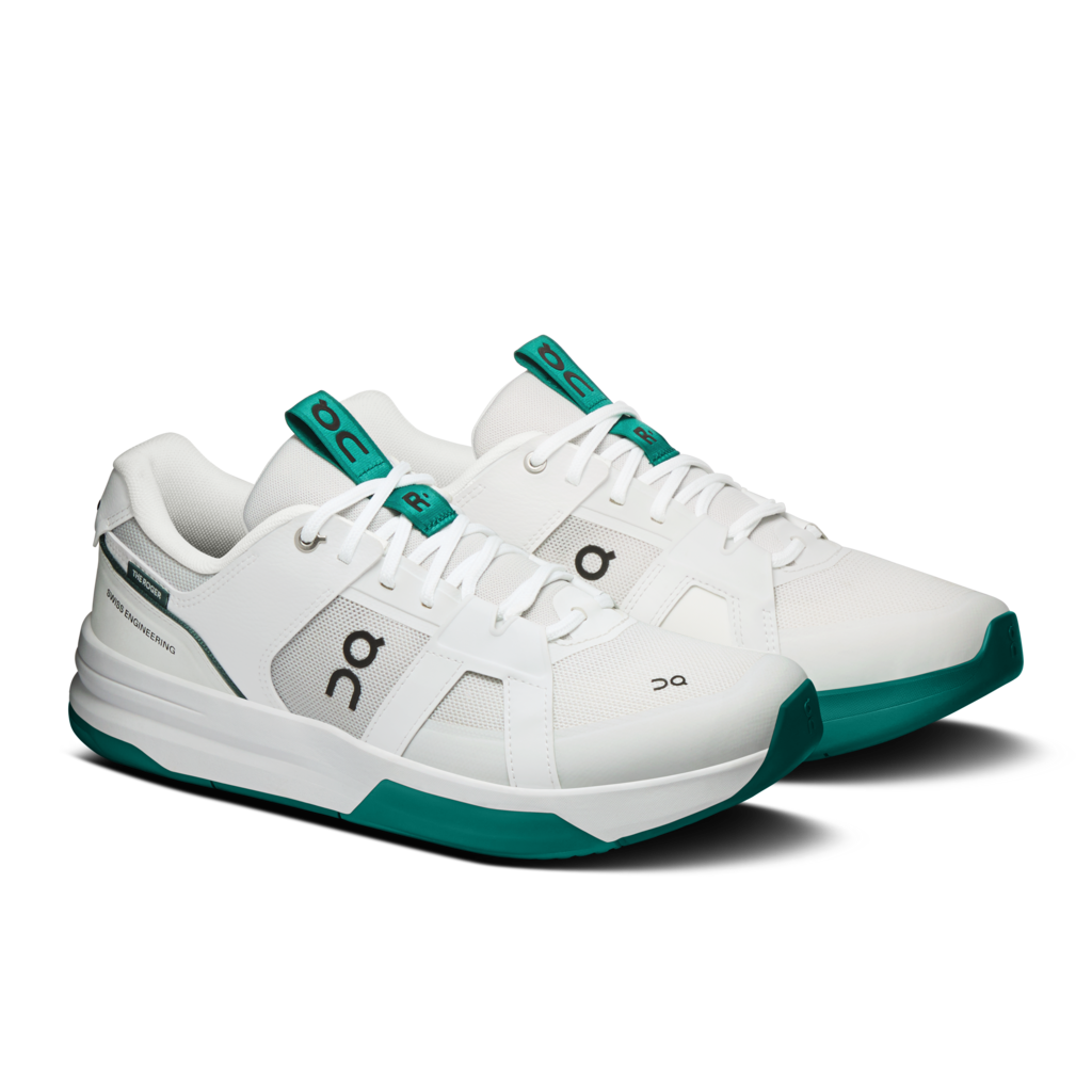 white and green pair of tennis playing shoes