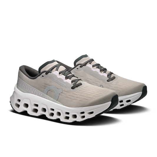 Pair of gray running shoes with white sole on a white background