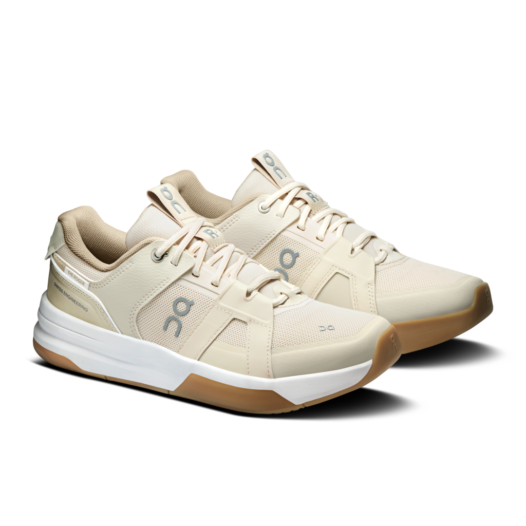 Beige colored pair of tennis playing shoes