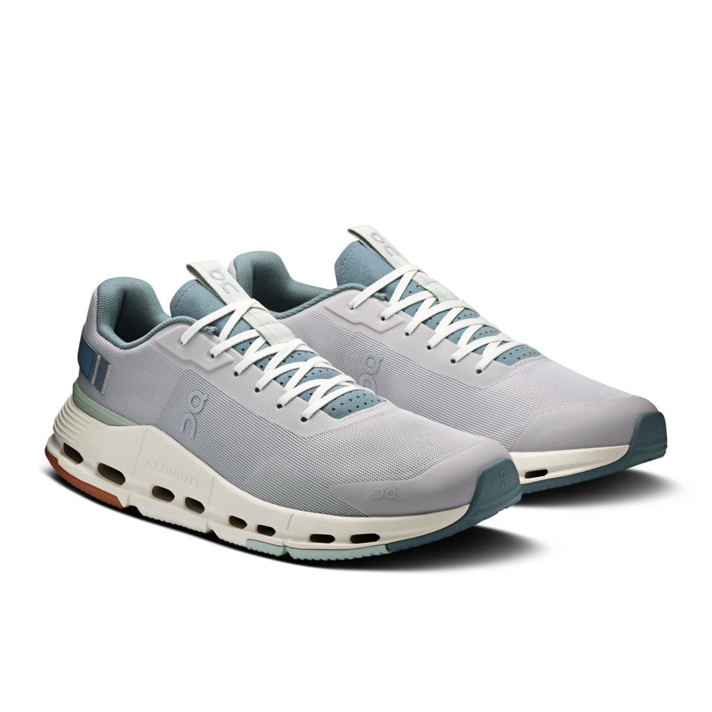 Pair of gray running shoes with white soles on a white background