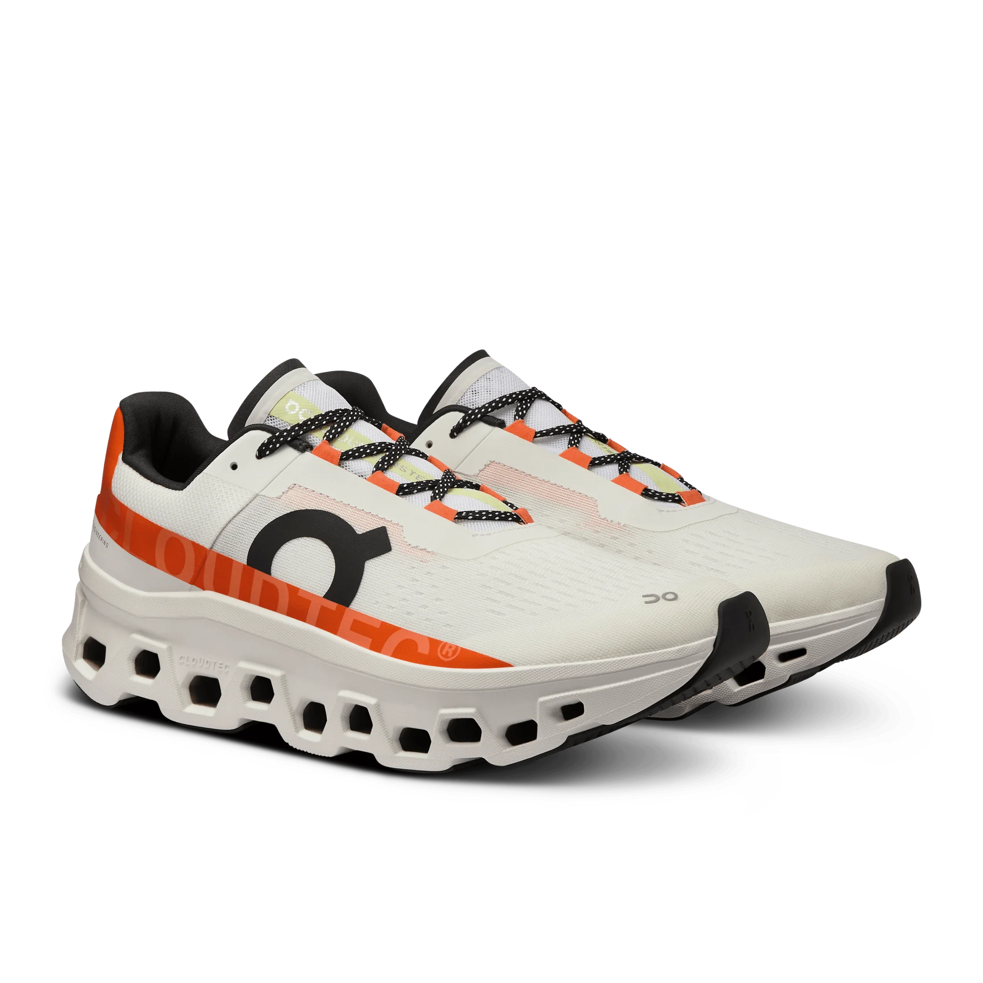 Angled lateral view of a pair of Women's white On Cloudmonster with orange and black detailing