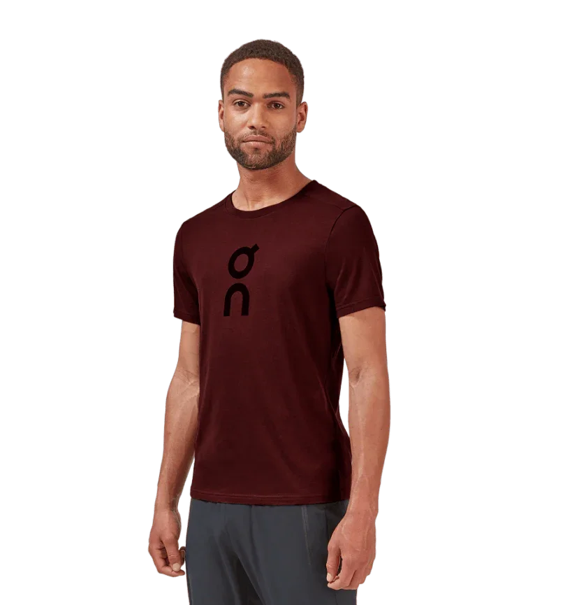Model wearing burgundy t-shirt with black velvet logo on chest