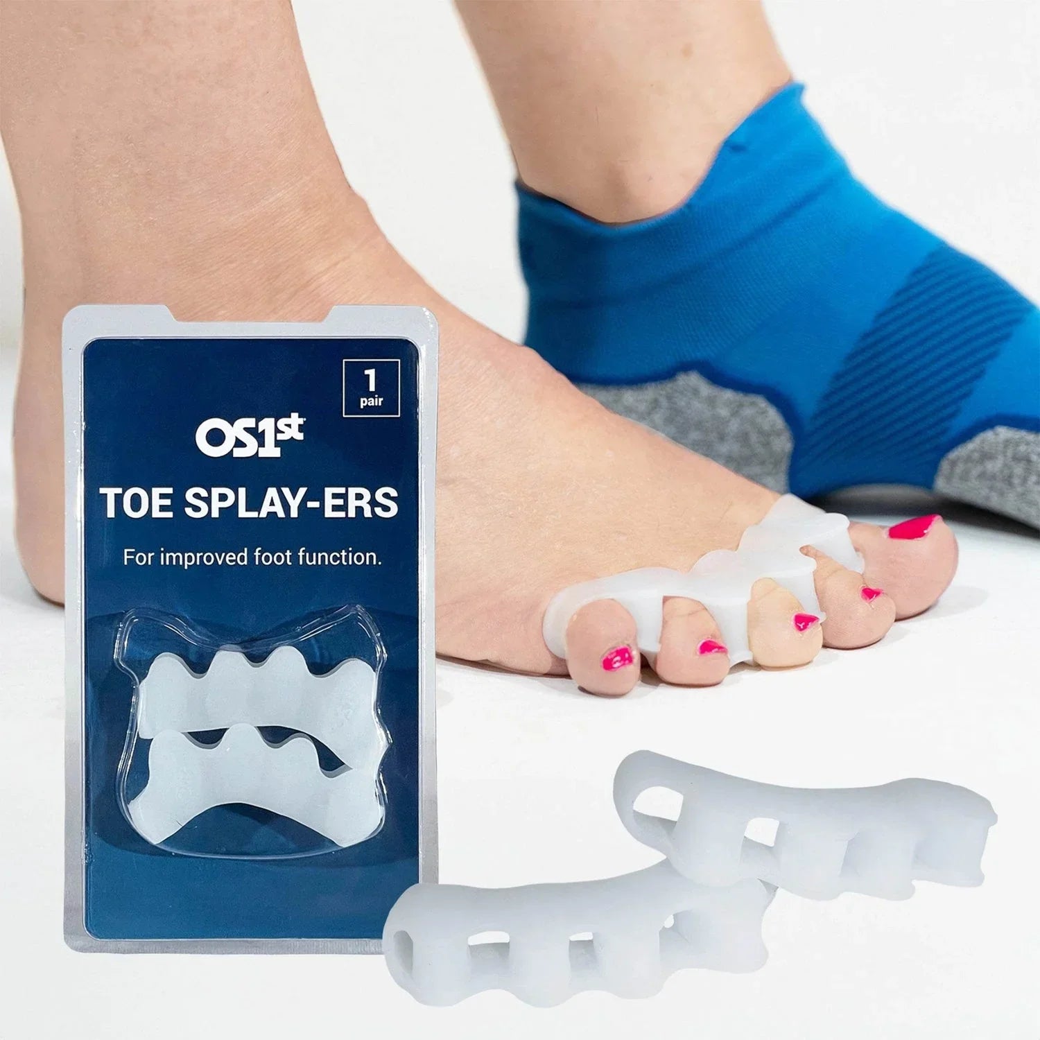 Toe splayers with packaging and a foot wearing them on a white background